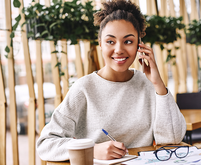 Woman smiling while talking on the phone with Ocoee dental office