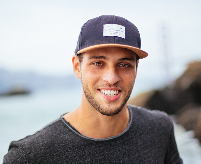 Young man wearing a baseball cap and smiling with dental implants in Ocoee