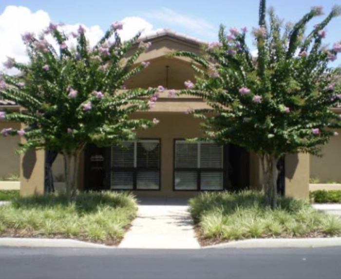 Two trees in front of the entrance to Maguire Comprehensive Dentistry in Ocoee