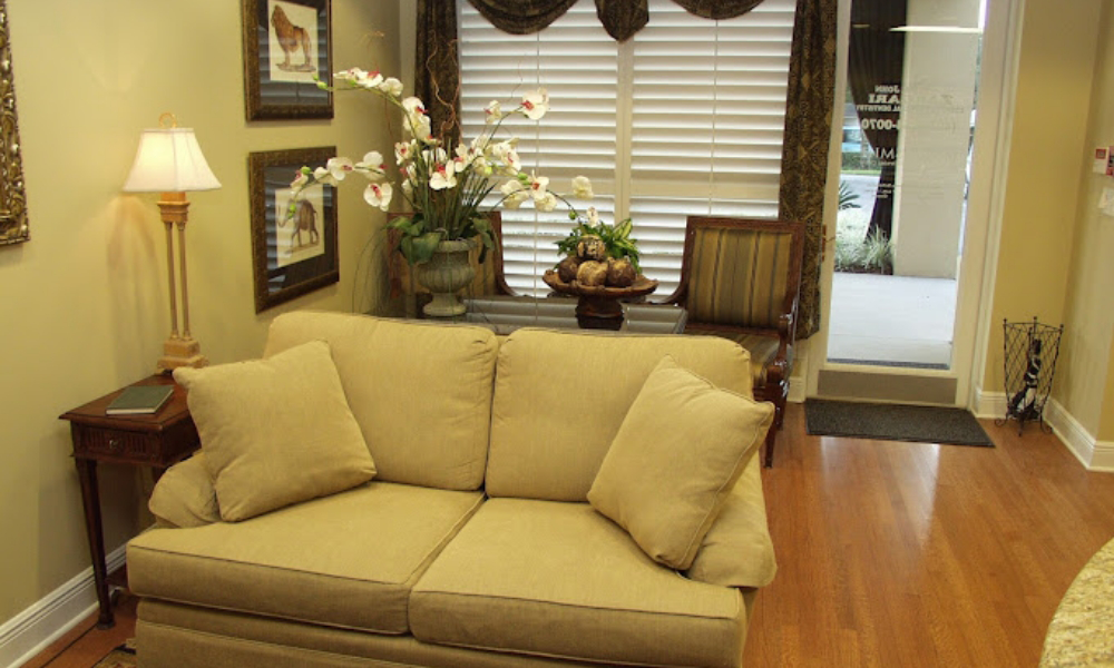 Yellow loveseat in dental office reception area