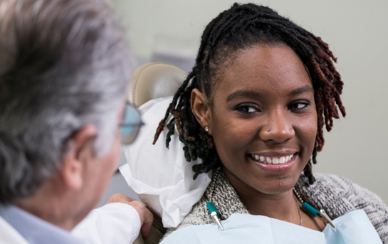 Female patient learning about the cost of teeth whitening in Ocoee 