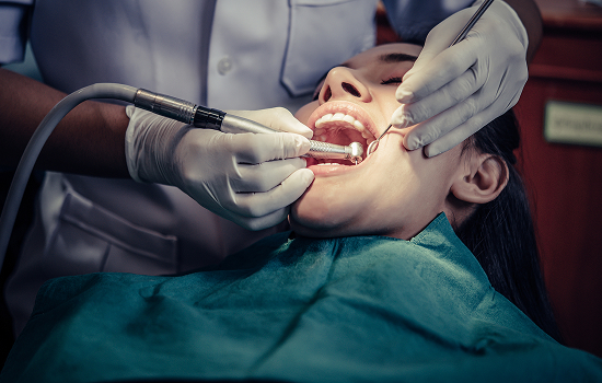 Dentist and assistant performing a dental procedure on a patient