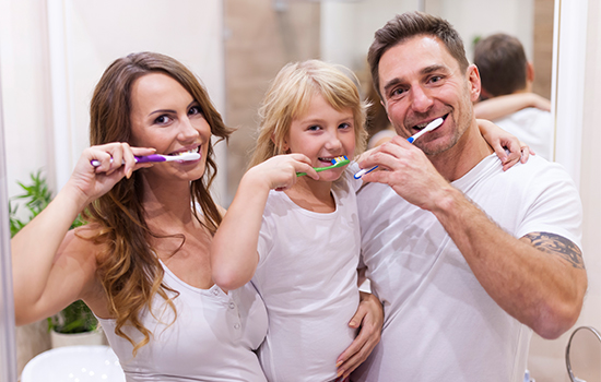 Dentist and assistant performing a dental procedure on a patient