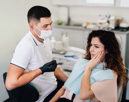 Dentist treating a patient during an urgent emergency dentistry procedure.